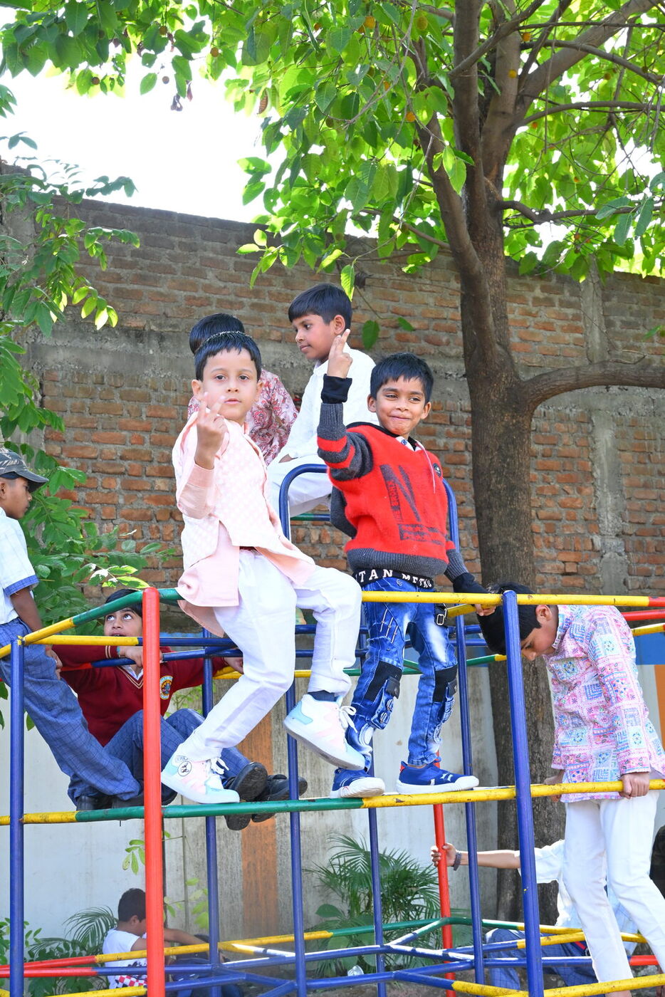 Young children play on the jungle gym in the school playground