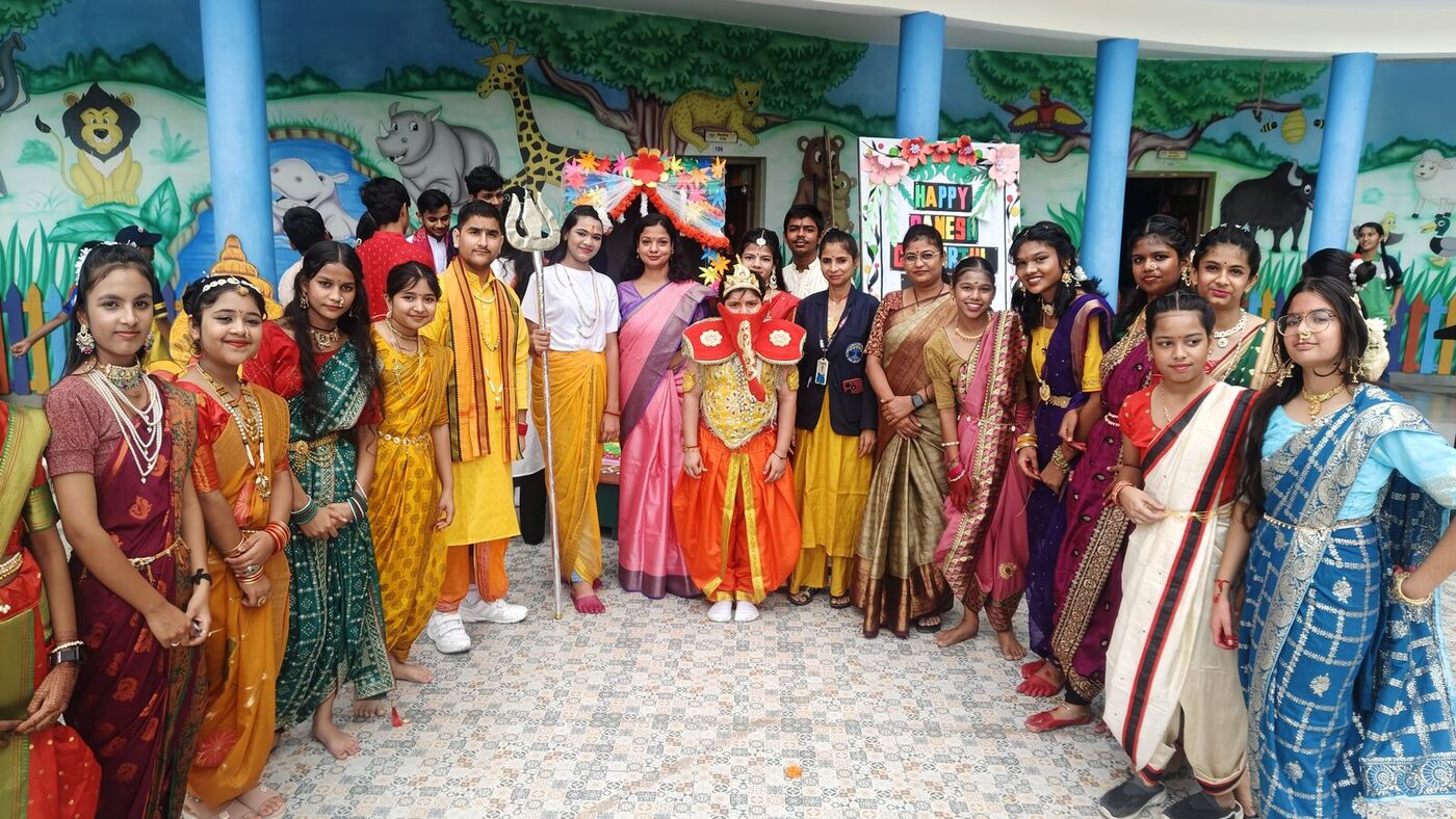 Students and teachers in traditional dress celebrate Ganesh Chaturthi in the courtyard