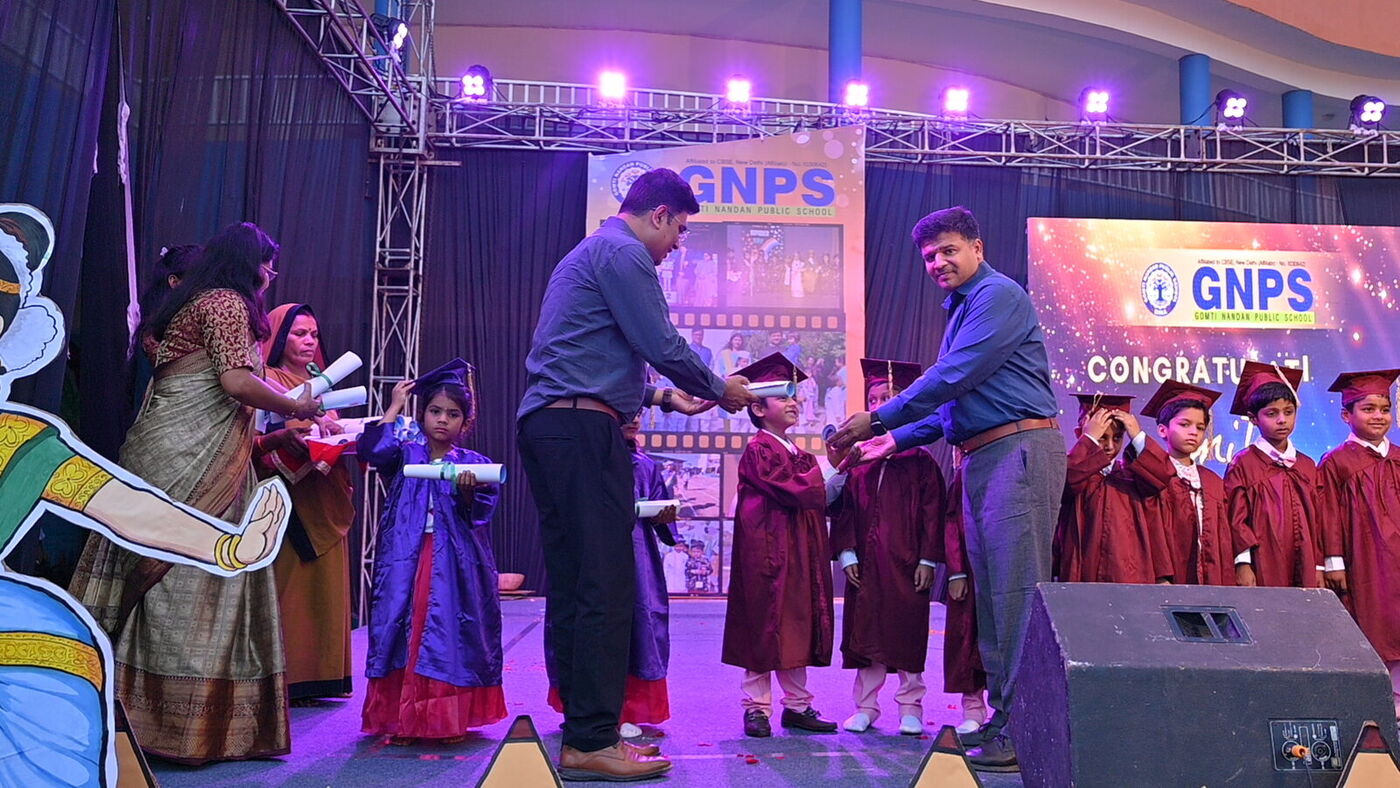 Graduates in caps and gowns are honoured on stage by school leaders at Graduation Day 2026