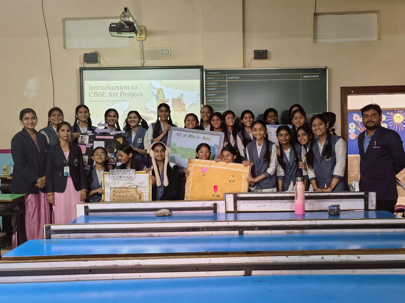 Class 9 Rose with their teacher and finished art-integrated science projects